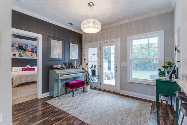 sitting room featuring crown molding, baseboards, visible vents, and wood finished floors