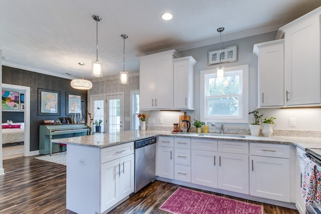 kitchen featuring a peninsula, plenty of natural light, white cabinets, a sink, and stainless steel appliances