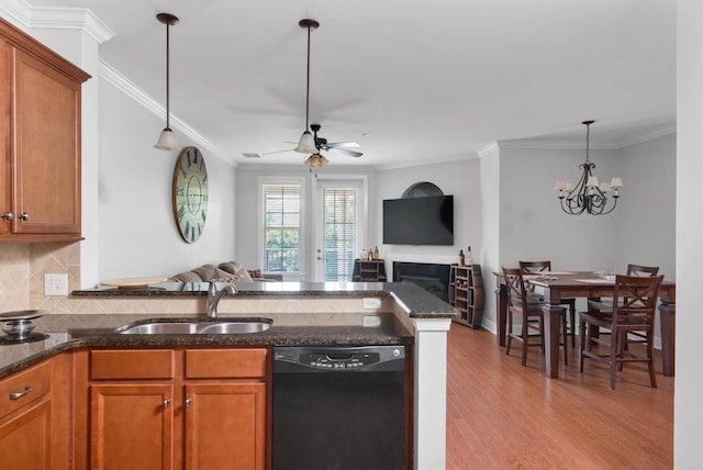 kitchen with a sink, black dishwasher, brown cabinets, and open floor plan