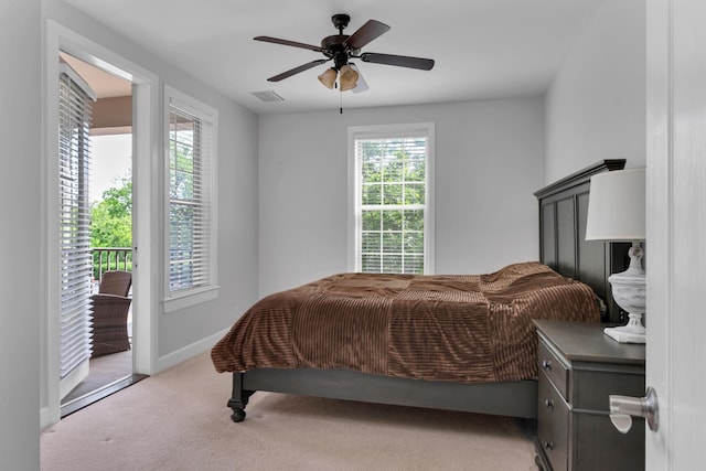 carpeted bedroom featuring access to outside, baseboards, visible vents, and ceiling fan
