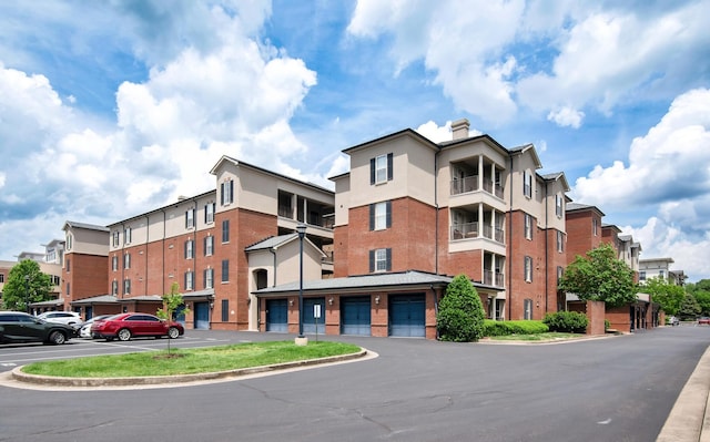 view of building exterior featuring uncovered parking