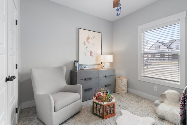 living area featuring baseboards