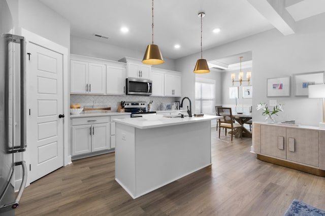kitchen featuring decorative backsplash, visible vents, dark wood finished floors, a sink, and stainless steel appliances