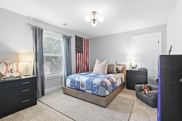 bedroom featuring visible vents and light carpet
