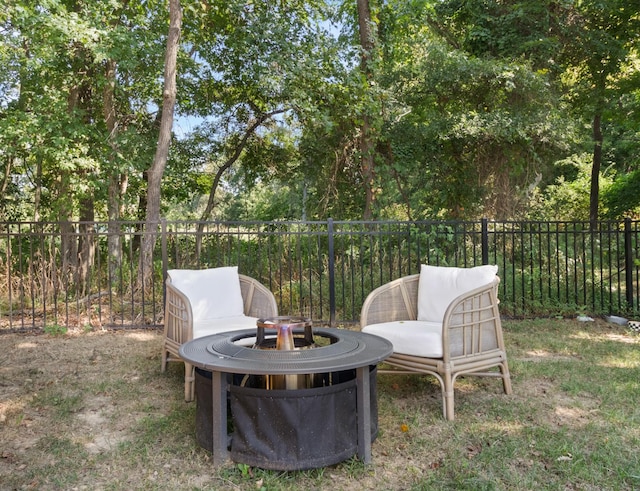 view of yard featuring a fire pit and fence