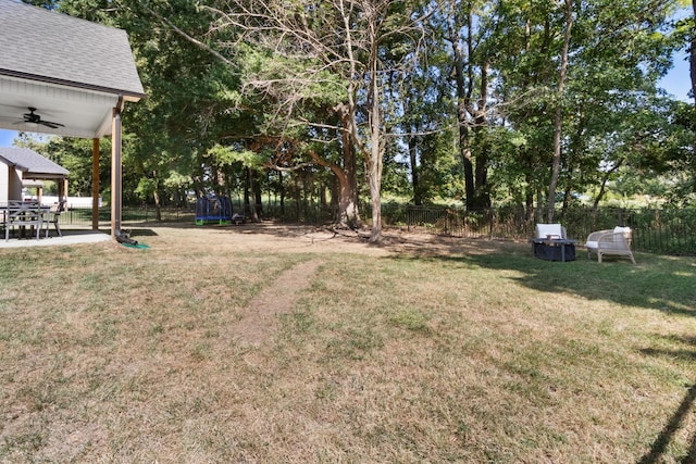 view of yard featuring a fenced backyard, a ceiling fan, and a patio