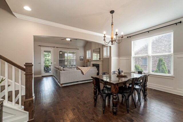 6006 Trotwood Ln, Spring Hill, TN 37174 - dining space with ornamental molding, stairs, wainscoting, a fireplace, and dark wood-type flooring