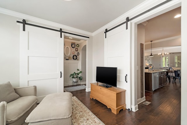 6006 Trotwood Ln, Spring Hill, TN 37174 - living area featuring baseboards, a barn door, dark wood finished floors, and ornamental molding