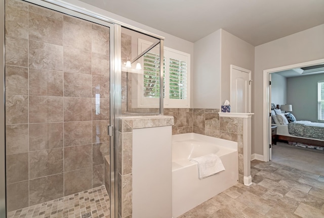 6006 Trotwood Ln, Spring Hill, TN 37174 - full bathroom with stone finish floor, baseboards, ensuite bathroom, a bath, and a stall shower