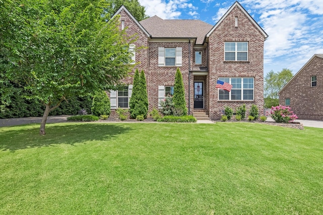 6006 Trotwood Ln, Spring Hill, TN 37174 - view of front facade featuring roof with shingles, a front yard, and brick siding