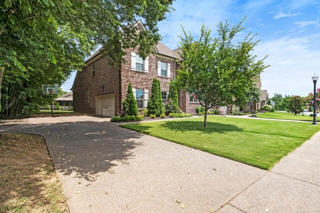 6006 Trotwood Ln, Spring Hill, TN 37174 - view of front of home featuring brick siding, a garage, a front lawn, and concrete driveway