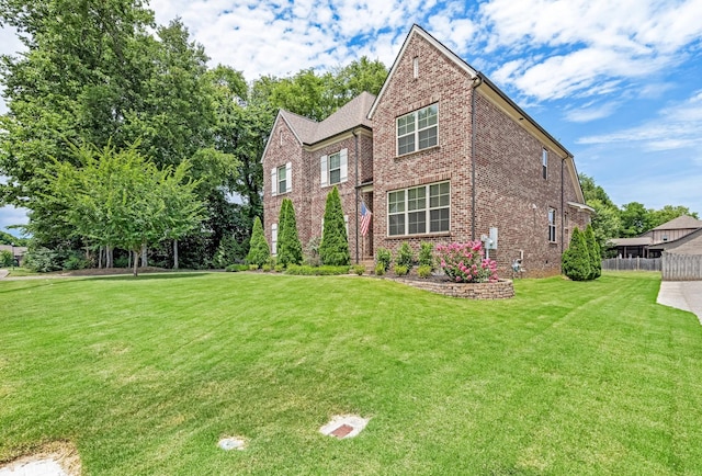 6006 Trotwood Ln, Spring Hill, TN 37174 - view of front of home with fence, a front yard, and brick siding