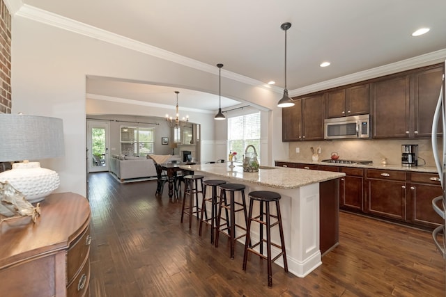 6006 Trotwood Ln, Spring Hill, TN 37174 - kitchen with stainless steel appliances, open floor plan, dark wood-type flooring, and a kitchen bar