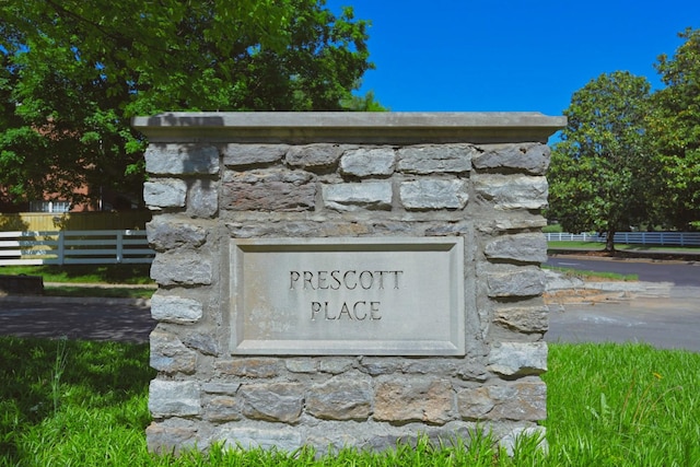 community / neighborhood sign featuring fence