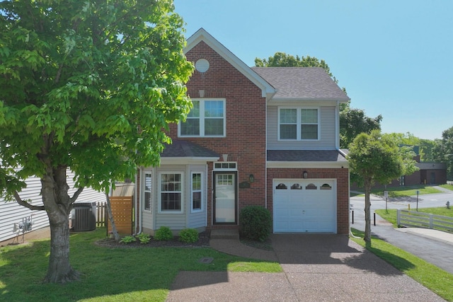 traditional home featuring fence, a front yard, roof with shingles, brick siding, and driveway