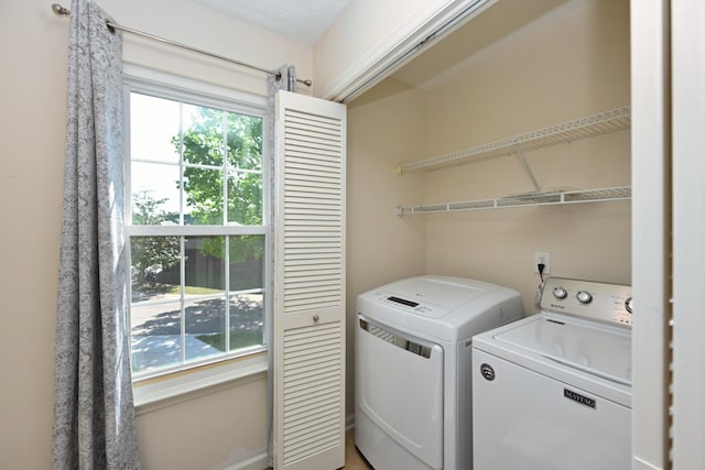 clothes washing area with laundry area and washing machine and clothes dryer