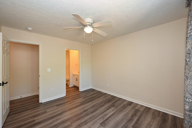 unfurnished bedroom featuring baseboards, dark wood-style flooring, and ceiling fan