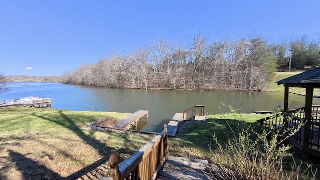 dock area with a yard and a water view