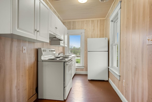 kitchen with wood finished floors, white cabinets, wooden walls, under cabinet range hood, and white appliances