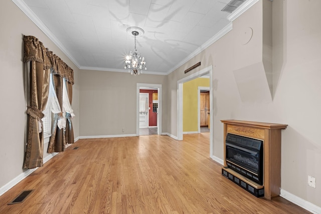 unfurnished dining area with an inviting chandelier, ornamental molding, light wood-type flooring, and visible vents