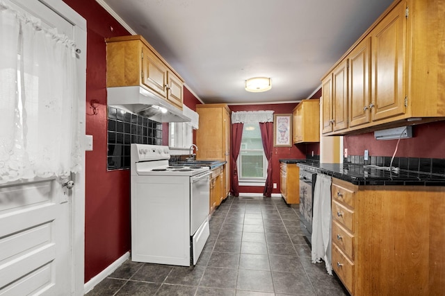 kitchen featuring under cabinet range hood, white range with electric cooktop, baseboards, and dark tile patterned flooring