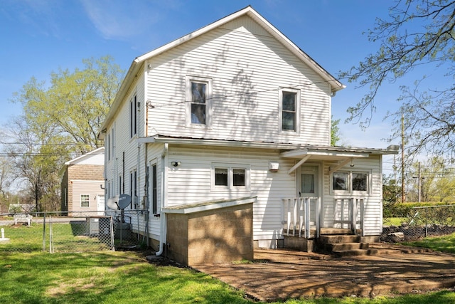 back of house with fence and a yard