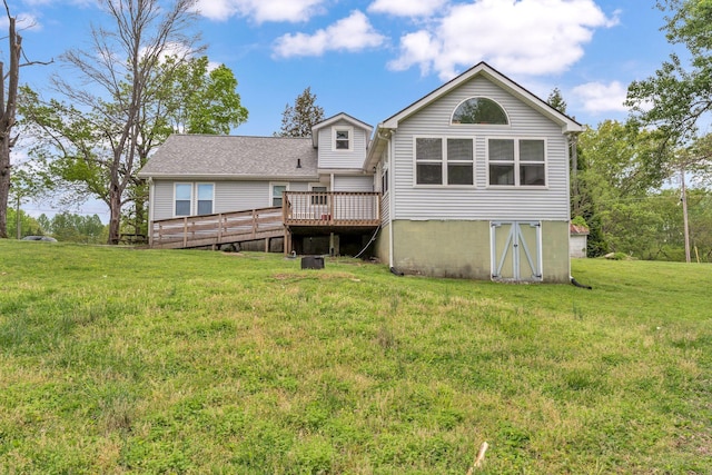 back of house featuring a yard and a deck