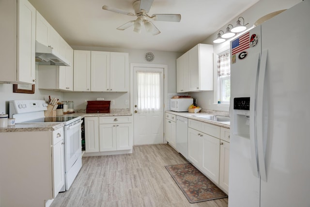 kitchen with white appliances, ceiling fan, under cabinet range hood, and light countertops