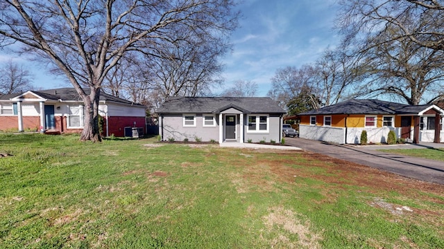 view of front of property with a front lawn and aphalt driveway