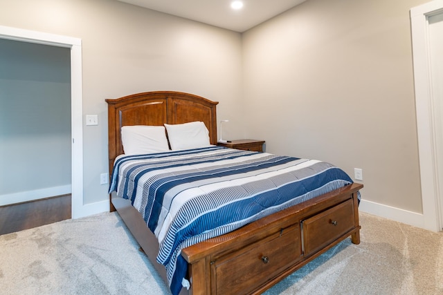 carpeted bedroom featuring baseboards and recessed lighting