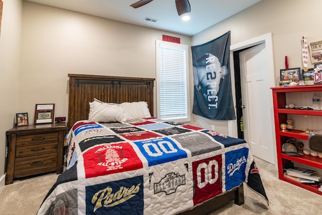 carpeted bedroom with visible vents and ceiling fan