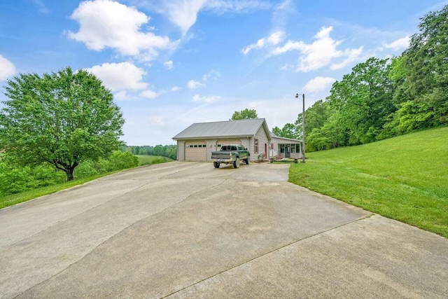1121 Walnut Grove Church Rd, Dayton, TN 37321 - view of front facade with an attached garage, driveway, metal roof, and a front lawn