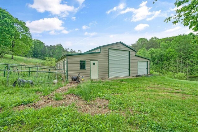 1121 Walnut Grove Church Rd, Dayton, TN 37321 - view of outbuilding featuring a forest view, fence, and an outbuilding