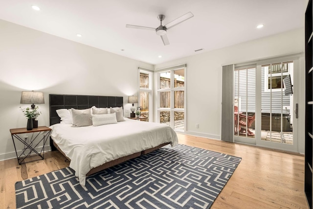 bedroom featuring baseboards, ceiling fan, wood finished floors, and access to exterior