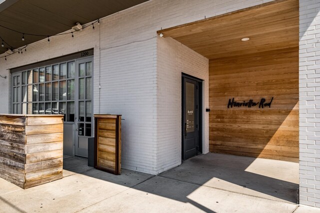 entrance to property with brick siding