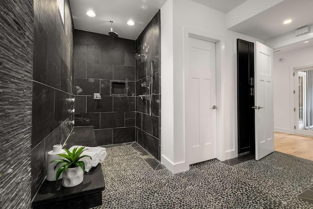 bathroom with recessed lighting and tiled shower