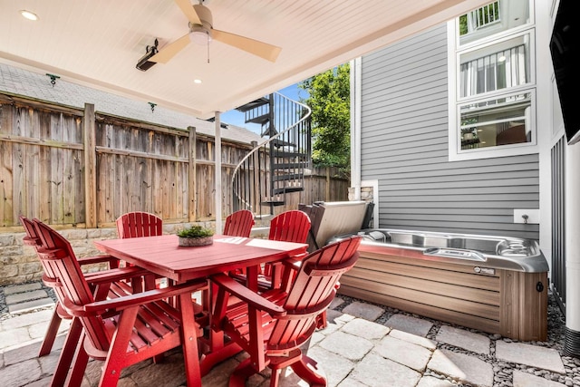 view of patio / terrace featuring ceiling fan, fence, outdoor dining area, and stairs