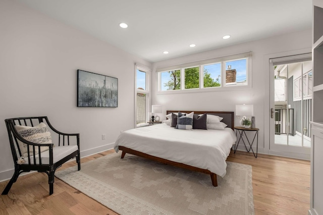 bedroom with light wood-type flooring, recessed lighting, and baseboards