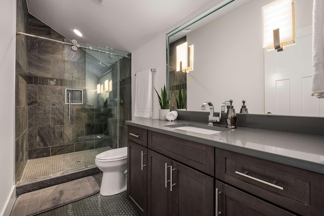 bathroom featuring vanity, tile patterned floors, a stall shower, and toilet