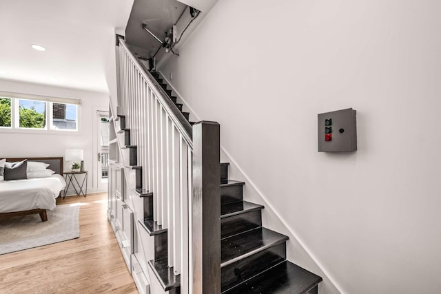 stairway featuring recessed lighting and wood finished floors