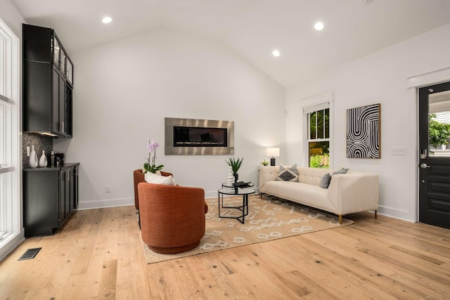 living area with recessed lighting, baseboards, visible vents, and light wood-style flooring