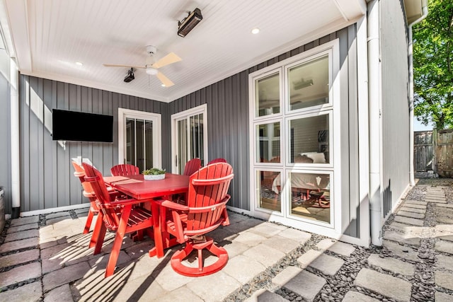 view of patio featuring a ceiling fan, fence, and outdoor dining space