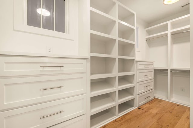 spacious closet featuring light wood finished floors and visible vents