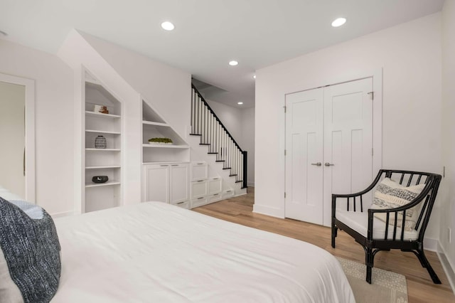bedroom with recessed lighting, baseboards, and light wood-style flooring