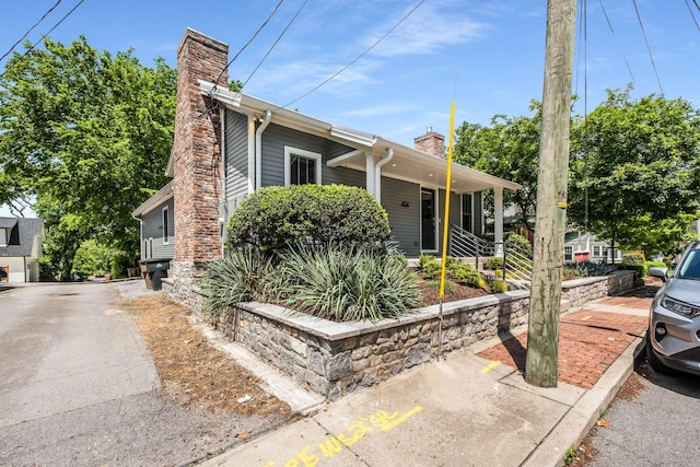 bungalow with a porch and a chimney