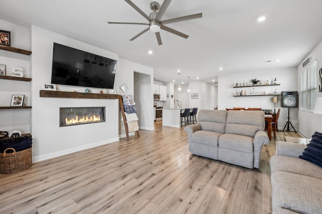 4326 Bomeadows Dr, Murfreesboro, TN 37128 - living area featuring recessed lighting, light wood finished floors, ceiling fan, and a glass covered fireplace