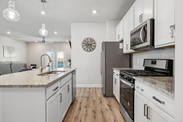 4326 Bomeadows Dr, Murfreesboro, TN 37128 - kitchen with white cabinets, a sink, stainless steel appliances, a ceiling fan, and tasteful backsplash