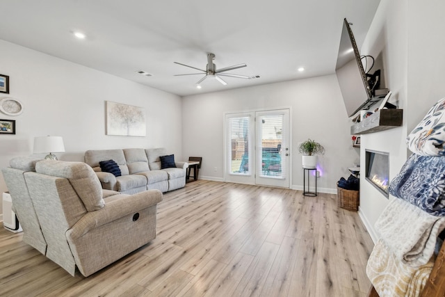 4326 Bomeadows Dr, Murfreesboro, TN 37128 - living room with visible vents, a glass covered fireplace, light wood-style floors, ceiling fan, and recessed lighting