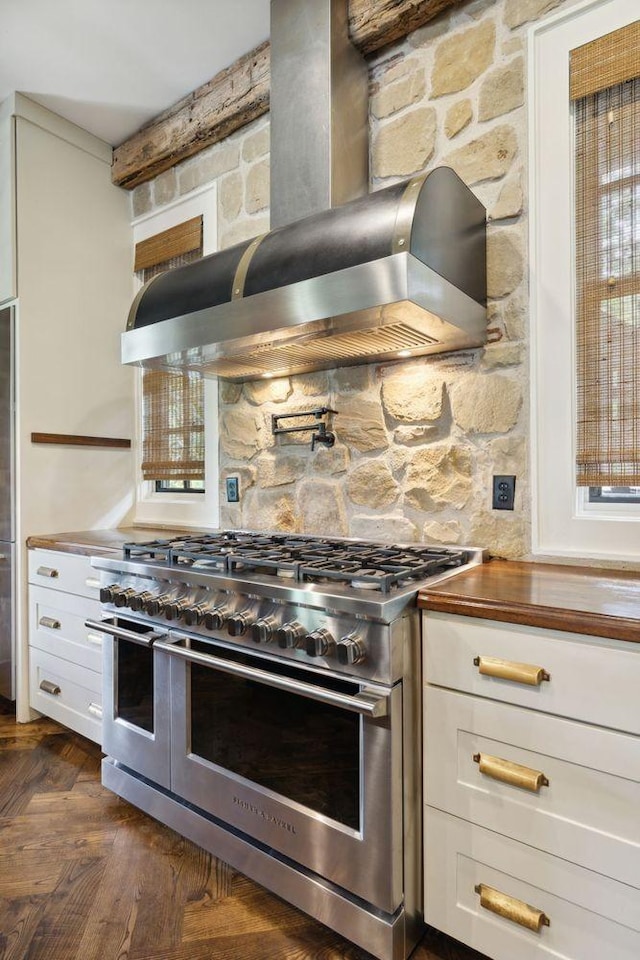 5715 Greenbrier Rd, Franklin, TN 37064 - kitchen featuring double oven range, tasteful backsplash, white cabinetry, wood counters, and extractor fan