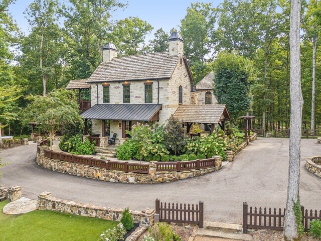 5715 Greenbrier Rd, Franklin, TN 37064 - view of front of home featuring fence, a chimney, a standing seam roof, and stone siding